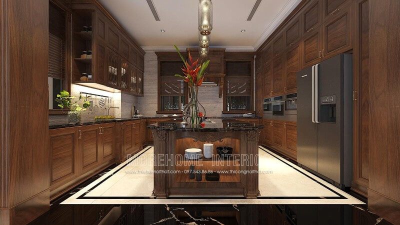 Thiết kế tủ bếp gỗ óc chó tân cổ điển tại Hà Nội kết hợp bàn đảo vừa mang lại độ bền cao, vừa biến một phần nhà bếp thành quầy bar hay bàn ăn phụ thuận tiện